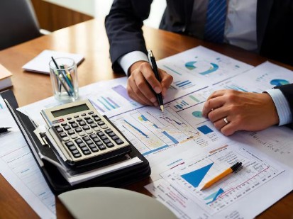 Accountant reviewing financial charts with a calculator